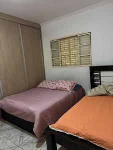 a bedroom with two beds and two windows at Chacara Oliva in Piracicaba +23 photos