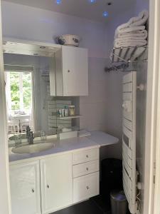 a white bathroom with a sink and a mirror at VILLA la GLORIETTE in Rouen +27 photos