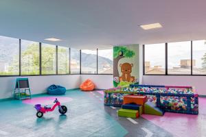 a childrens room with a scooter in the middle at Bizsar 1003 AC Increíbles terrazas y Piscina in Ibagué
