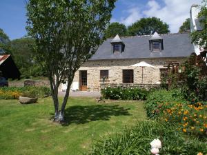 a stone house with a tree in the yard at Charming Stay in Pont-Croix in Pont-Croix