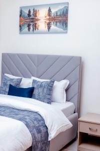 a bedroom with a bed with blue and white pillows at Sereno Escape in Meru