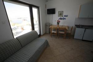 a living room with a couch and a table at Apartments Roza in Miškovići
