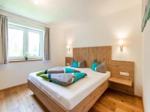 a bedroom with a large bed with a wooden headboard at Chalet in Ötz near Hochötz Ski Lift in Oetz