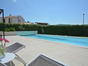 a swimming pool in a yard with a table at Villa in Malaucène near Mont Ventoux in Malaucène +32 photos
