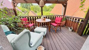 a patio with chairs and a table on a deck at Luxuriöse Ferienwohnung mit 3 Schlafzimmern in Tremsbüttel