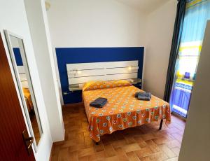 a small room with a bed with an orange table at App 2 Studio Wohnung 2 Plätze in Cattolica Eraclea