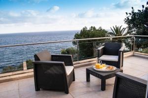 a patio with two chairs and a table with drinks on it at Cas Forner in Cala Pi