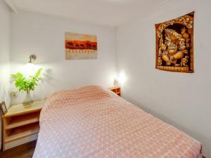a bedroom with a bed and a picture on the wall at Chalet in Stegeren with Pool and Gardens in Stegeren +32 photos