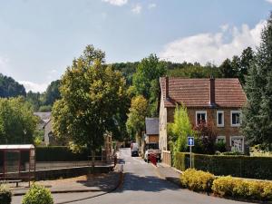 a street in a small town with houses and trees at Clos du Bannet Family Escape in Givonne