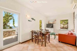 a living room with a table and chairs and a dining room at Le Onde di Rio, TerreMarine in Riomaggiore