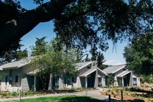 a row of white houses with roofs at Ein Zivan Village Resort in Ein Zivan