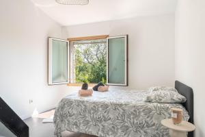 a bedroom with a bed with two stuffed animals on it at Villa le Trèfle with pool in Velaux +30 photos