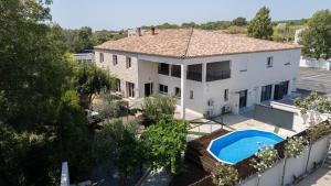 an aerial view of a house with a swimming pool at Villa le Trèfle with pool in Velaux