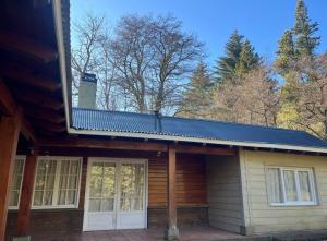 a house with a solar roof on top of it at Casa en medio de la montaña in San Martín de los Andes