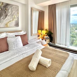 a bedroom with a large bed with a large window at AEON TOWERS 1BR unit beside abreeza mall in Davao City