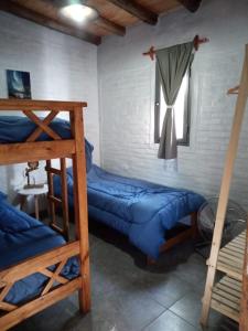 a bedroom with two bunk beds and a window at Cabañas Universo in San Rafael +25 photos