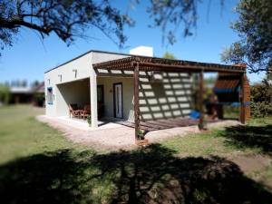 a small white building with a pavilion at Cabañas Universo in San Rafael