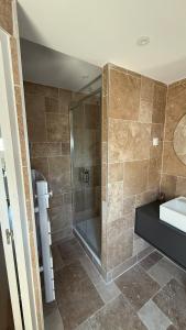 a bathroom with a shower and a sink at Le joli strasbourgeois in Caen +2 photos
