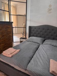 a bedroom with a large bed with a large mirror at Apartmán 6- Self check-in in Spišské Podhradie