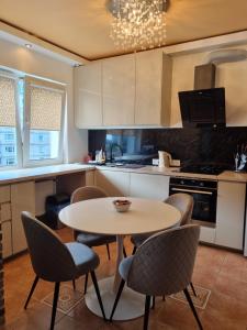 a kitchen with a table and chairs in it at Exclusive Golden Sands apartment in Riga