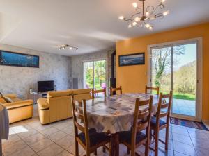 a dining room and living room with a table and chairs at Coastal Retreat in Plurien in Plurien