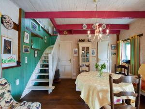 a dining room with a table and a staircase at Breton Escape in Querrien in Coatviller