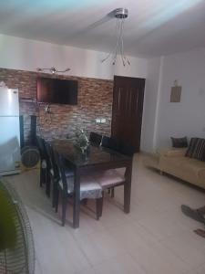 a living room with a table and a couch at North Coast chalet for rent in Dawwār Abū Duray‘ah ‘Abd al Karīm