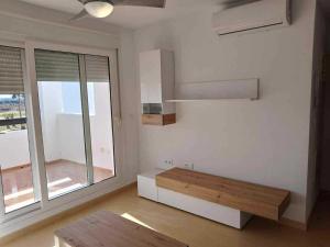 a living room with a bench and a window at Appartement Las Terrazas De La Torre in Las Pedreñas