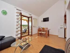 a living room with a couch and a table at Holiday Home in Krusevo with Garden & BBQ in Kruševo