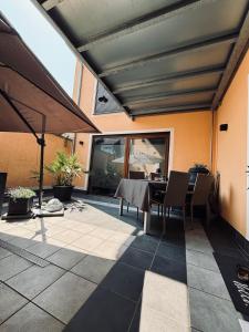 a patio with a table and chairs and a building at Da Toni FeWo Chiara in Rüdesheim am Rhein +12 photos