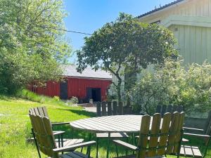 a picnic table and chairs in a yard with a red barn at Charming Villa Retreat-By Traum in Varekil