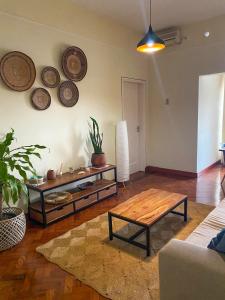 a living room with a table and plates on the wall at Patri House in Maputo