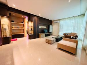 a large living room with a couch and a table at Exclusive Bungalow Private & Peaceful in Miri Ocean Park 5BR in Miri