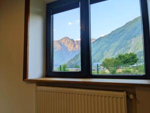 a window with a view of a mountain at AGRE Kazbegi in Ach'khoti