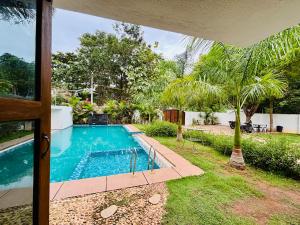 a swimming pool in the backyard of a house at Courtyard Castle Heritage Resort in Puducherry