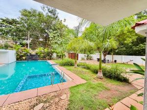 a swimming pool in the backyard of a house at Courtyard Castle Heritage Resort - Private Villa & Rooms in Pondicherry