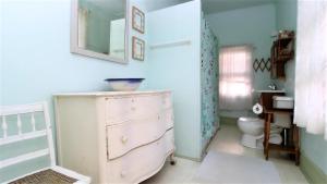 a bathroom with a white dresser and a toilet at May Caper - Second Floor in Cape May
