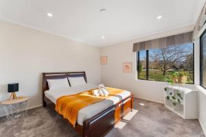 a bedroom with a bed and a large window at Relax Countryside in Turangi
