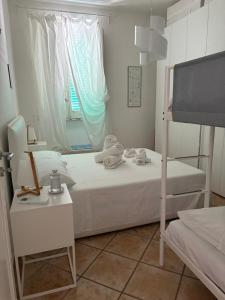 a small bedroom with a bed and a window at Casa Libera in Savelletri di Fasano