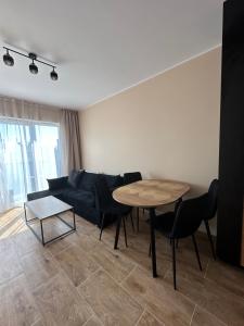 a living room with a blue couch and a table at Magic Jar in Toruń +2 photos