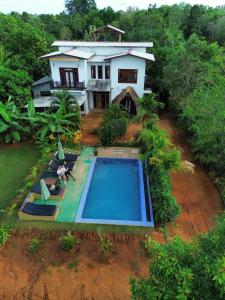 an aerial view of a house with a swimming pool at Dew Ashi Homestay in Sigiriya