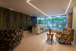 a lobby with chairs and a table and a store at Forest Keys By VYDA in Bangalore
