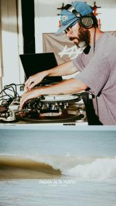 a man with headphones and a laptop on a table at Piedra Alta Hostel & Suites in La Pedrera +55 photos