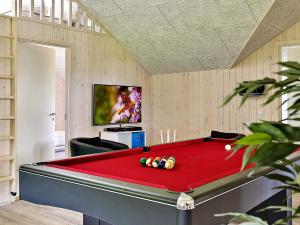 a room with a pool table and a tv at 5 star holiday home in Stege in Stege