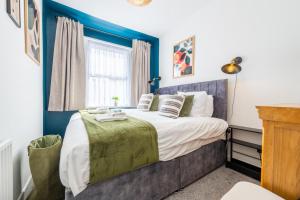 a bedroom with a large bed and a window at Emerald House by Tŷ SA in Newport +7 photos