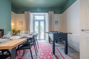 a dining room with a table and chairs at Emerald House by Tŷ SA in Newport