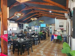 a dining room with people sitting at tables in a restaurant at Hotel Cañas in Cañas