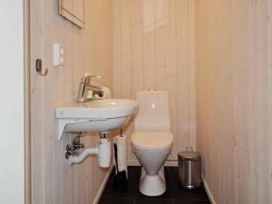 a small bathroom with a toilet and a sink at 4 star holiday home in Øyer in Øyer +18 photos