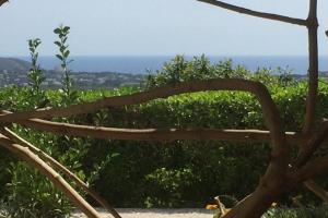 a wooden bench sitting on top of a field at Coastal Villa Near Beaches in Moraira +21 photos