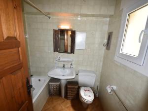 a small bathroom with a sink and a toilet at Coastal Villa Near Beaches in Moraira